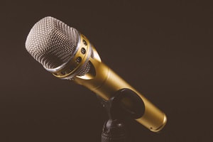 gold microphone on black background