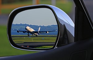 image of airplane in rear-view mirror