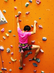 young man on climbing wall