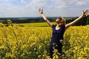 woman embracing the sunshine in a field
